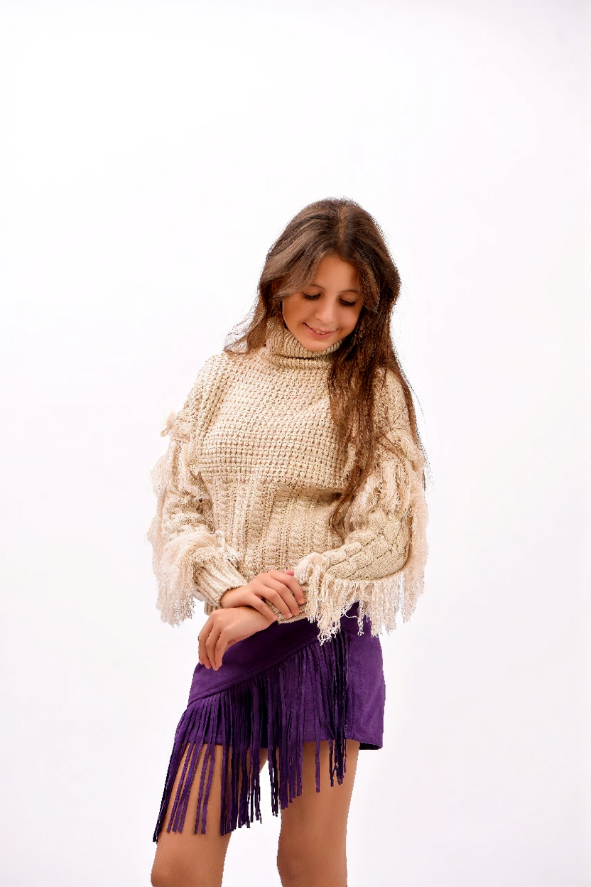 fringe detailing along the sleeves and sides sweater
