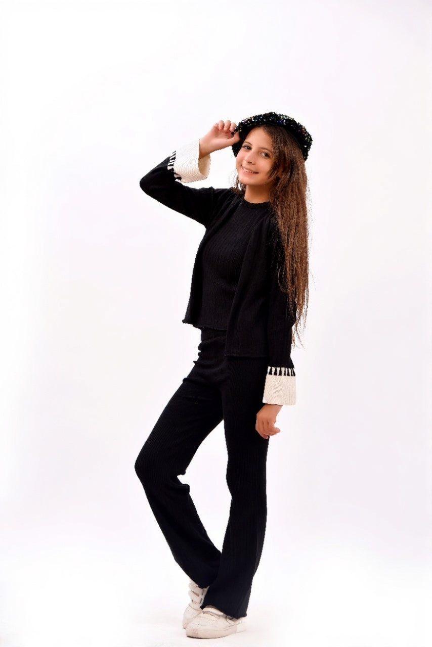 ribbed black top paired with a matching open-front cardigan